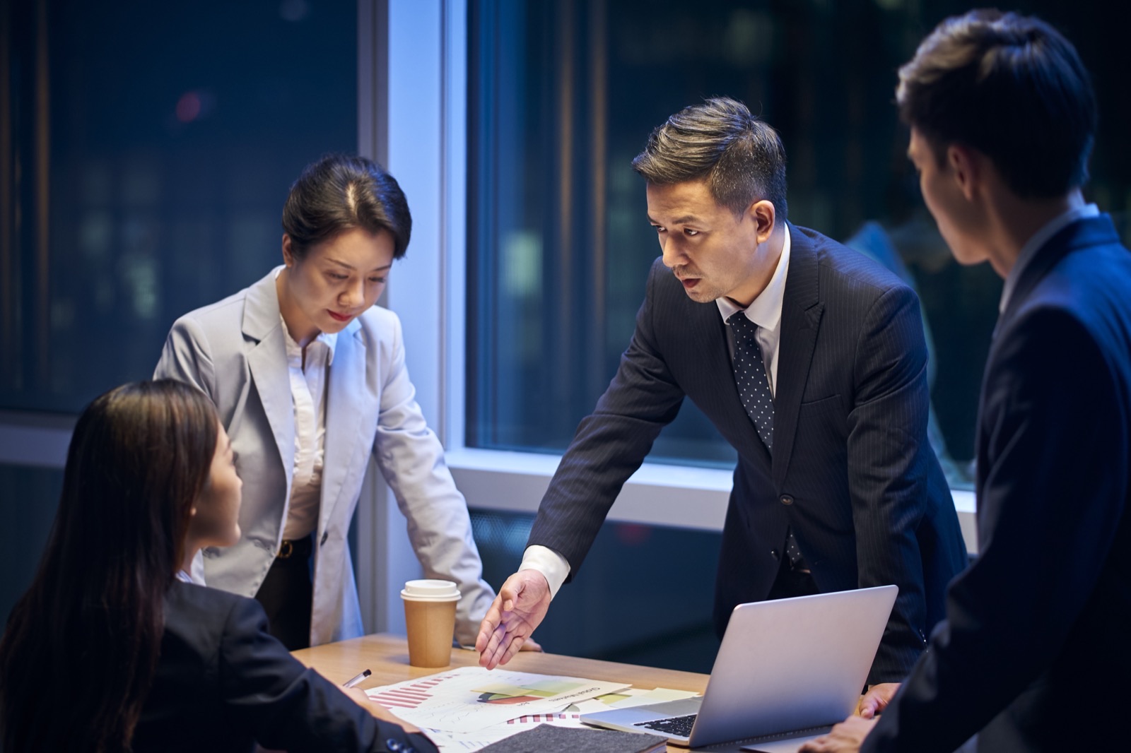 A project team working late together in a meeting