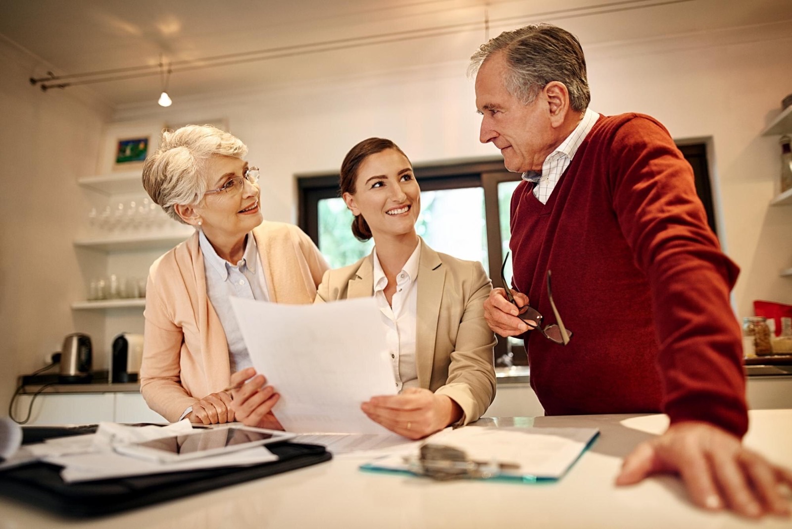 A senior couple reviewing budget planning documents with a lawyer